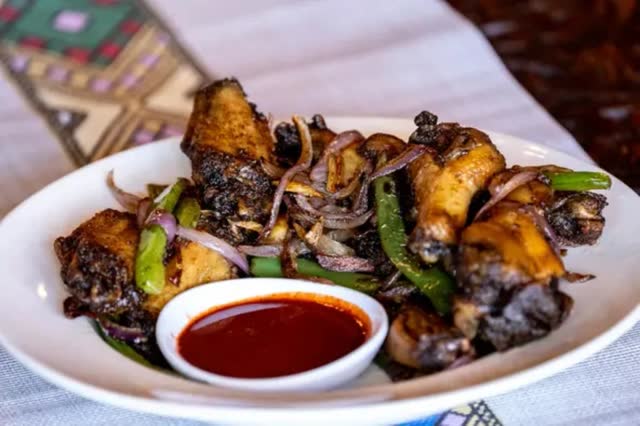 Awaze wings with onions and peppers